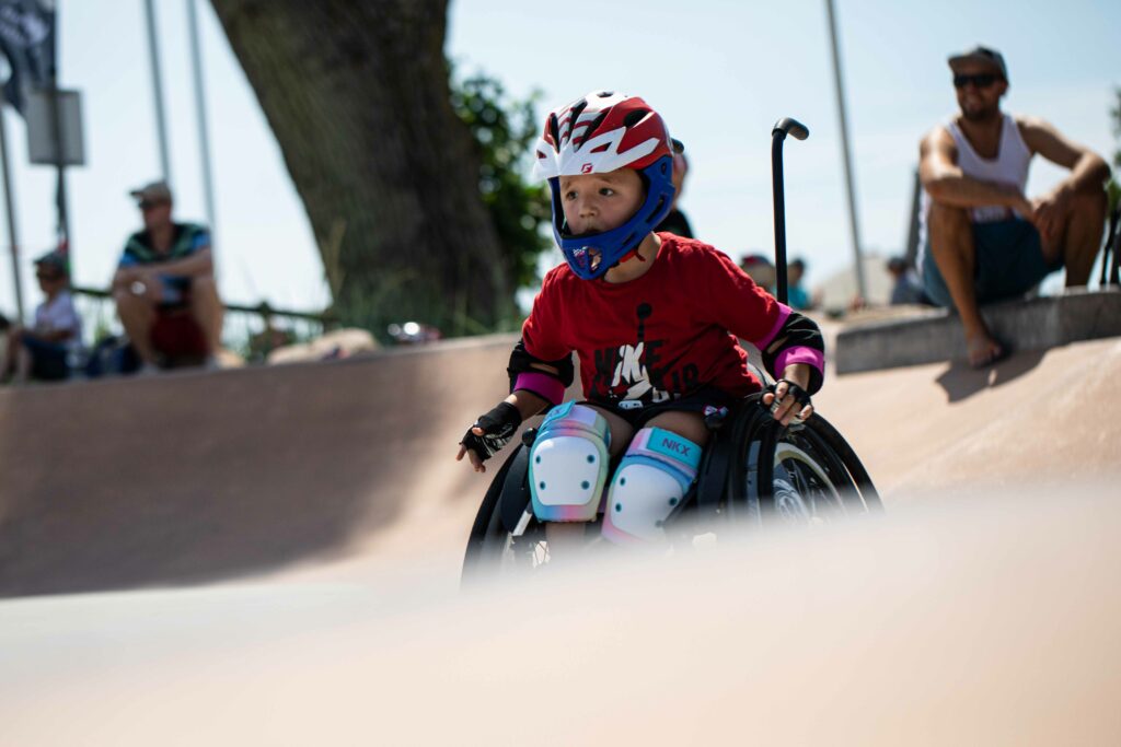 Ein Kind im Rollstuhl im Skatepark.